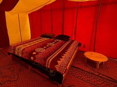 a bedroom with a bed in a tent at Bivouac Les Nomades & Foum zguid camel trekking and tours in Foum Zguid