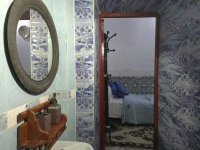 a bathroom with a mirror and a sink at Dar Enouiina in Fès