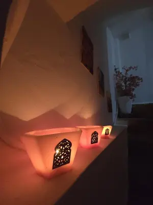 a room with orange lights on a wall at Dar Enouiina in Fès