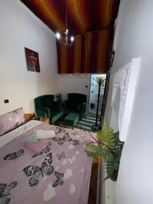 a bedroom with a bed with a butterfly blanket at Dar Enouiina in Fès