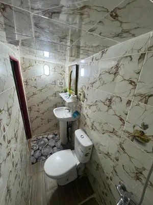 a bathroom with a toilet and a sink at Dar Enouiina in Fès