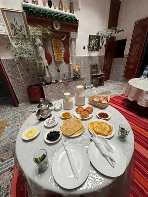 a table with plates of food on top of it at Dar Enouiina in Fès