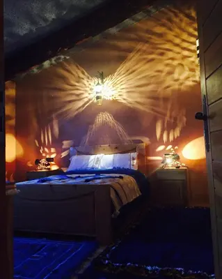 a bedroom with a bed and two lights on the wall at La pommeraie d'Ifrane in Ifrane