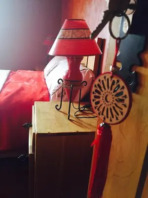 a red lamp on a table next to a bed at La pommeraie d'Ifrane in Ifrane
