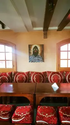 a living room with a red couch with red cushions at La pommeraie d'Ifrane in Ifrane