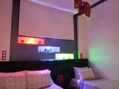 a room with a couch and a projection screen on the wall at Ryan 1 in Fès