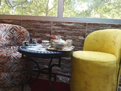 a table and two chairs and a table and a table and chairs at Ryan 1 in Fès