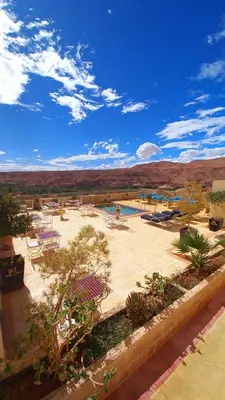 a park with a pool and tables and chairs at Ksar Sultan Dades - Dades Valley Retreat in Boumalne