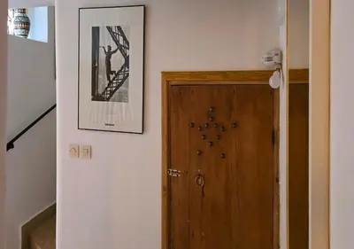 a hallway with a door and a picture on the wall at Dar Le 44 in Fès