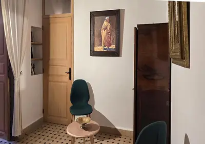 a room with a blue chair and a door at Dar Le 44 in Fès