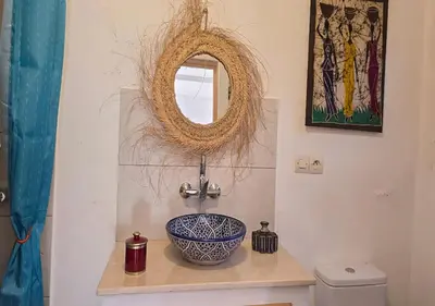 a bathroom with a sink and a mirror at Dar Le 44 in Fès