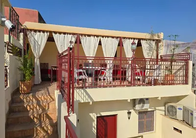a balcony with tables and chairs on a building at Dar Le 44 in Fès