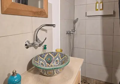 a sink in a bathroom with a shower at Dar Le 44 in Fès