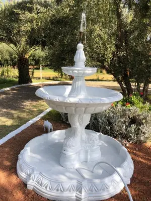 a white fountain in the middle of a park at Teacook Marrakech in Ouled el guerne