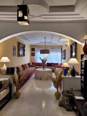 a living room with a couch and a table at Appartement de haut standing in Fès