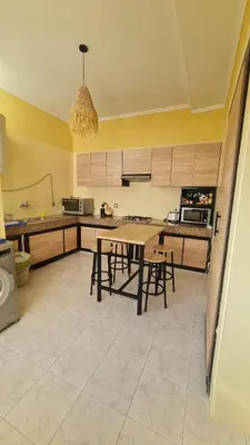 a kitchen with a table and some chairs in it at Appartement de haut standing in Fès