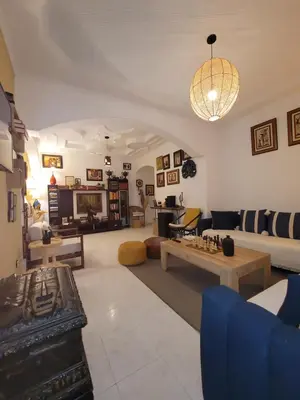 a living room with a couch and a table at Appartement de haut standing in Fès