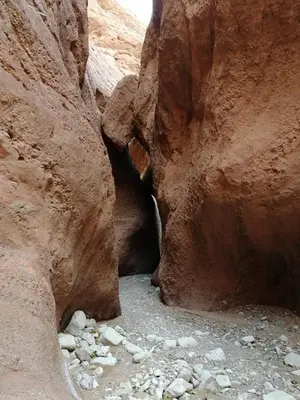 a cave in a canyon with rocks in it at Maison D'hote Chez La Famille in Tamellalt
