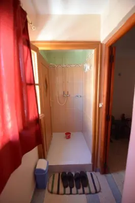 a small bathroom with a shower with a tub at Hotel Imilchil in Zaouiat Cheikh