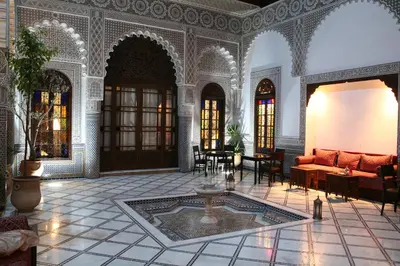 a living room with a couch and a table at Riad Batchisarai in Fès