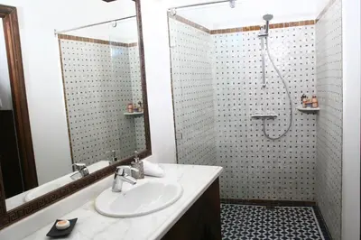 a bathroom with a sink and a shower at Riad Batchisarai in Fès