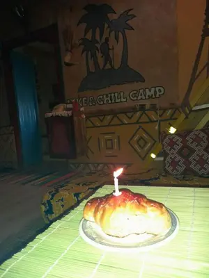 a candle in a pastry sitting on top of a table at Hike and Chill Homestay in Tinerhir