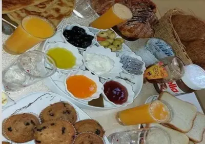 a table with eggs and bread and glasses of orange juice at berber sahara in Zagora