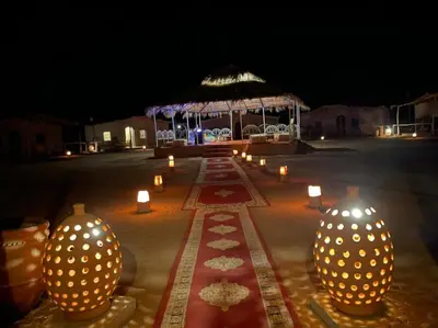 a group of vases with candles in front of a building at berber sahara in Zagora