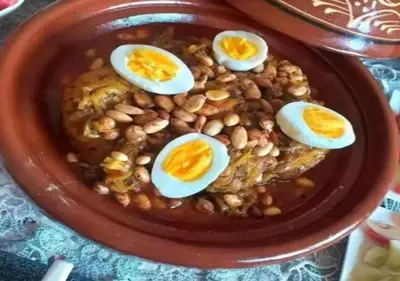 a plate of food with eggs on top of beans at berber sahara in Zagora