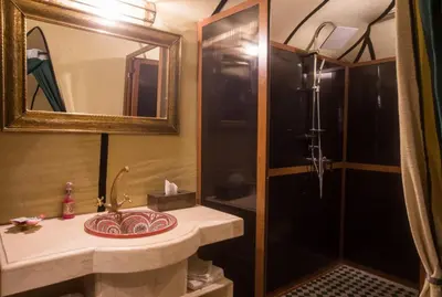 a bathroom with a sink and a shower at Luxury Desert Camp Amanar in Merzouga