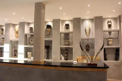 a museum exhibit with vases and vases on shelves at Bab Rimal - Desert Hotel in M'hamid El Ghizlane in Mhamid