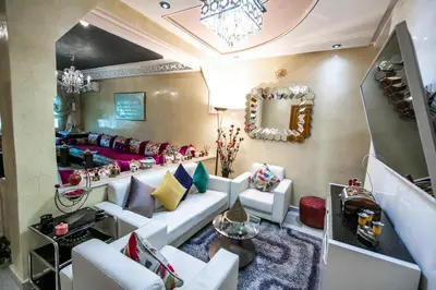 a living room with a couch and a mirror at Appartement Luxe Simo in Fès