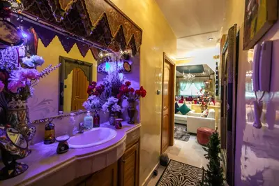 a purple bathroom with a sink and a mirror at Appartement Luxe Simo in Fès