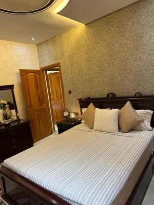 a bedroom with a large bed with white sheets at Appartement Luxe Simo in Fès