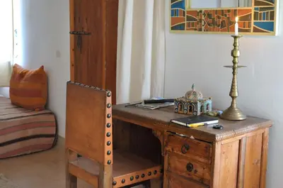 a wooden desk with a lamp and a chair at Le Douar Berbere in Ourika
