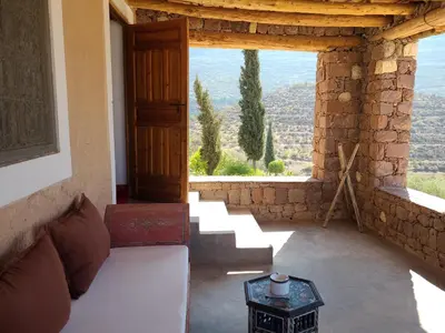 a living room with a couch and a large window at Le Douar Berbere in Ourika