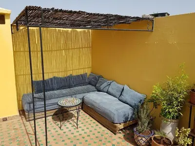 a living room with a blue couch in a room at Riad Inspira in Meknès