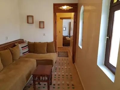 a living room with a couch and a table at Riad Inspira in Meknès