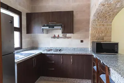 a kitchen with a sink and a microwave at Résidence Hôtelière Le Diamant Vert in Fès