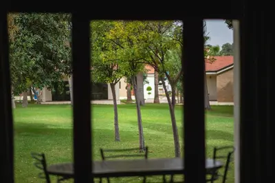 a view of a park from a window at Résidence Hôtelière Le Diamant Vert in Fès