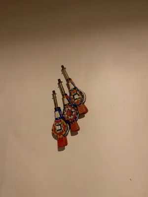 a group of four violins hanging on a wall at Chez Youssef in Merzouga