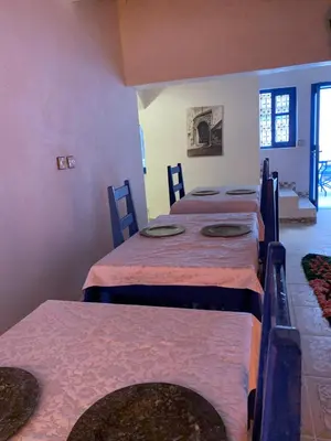 a room with four beds in a room at Chez Youssef in Merzouga