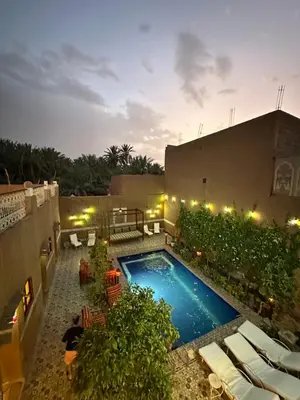 an overhead view of a swimming pool at night at La Petite Kasbah in Zagora
