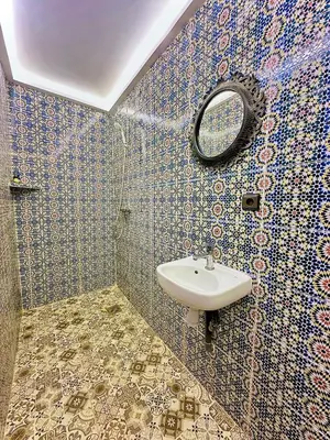 a bathroom with a sink and a mirror at La Petite Kasbah in Zagora