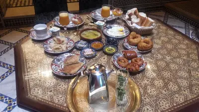 a table topped with plates of food on a table at Riad Al Fassia Palace in Fès