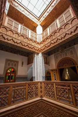 an ornate room with a ceiling and a balcony at Riad Al Fassia Palace in Fès