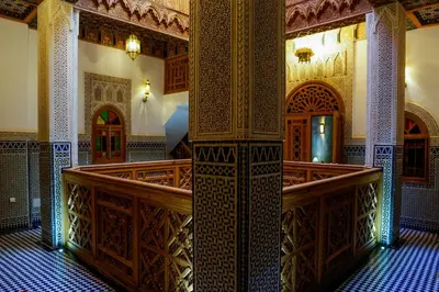 a mosque with a staircase and a room with ornate ceilings at Riad Al Fassia Palace in Fès