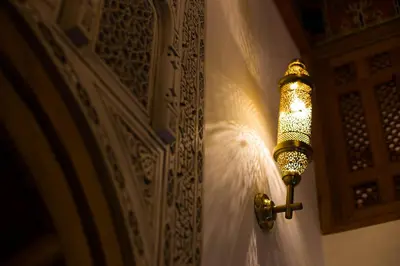 a light on a wall next to a wall at Riad Al Fassia Palace in Fès