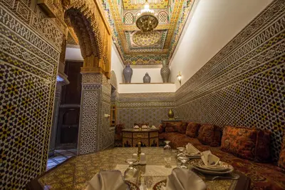 a living room with a couch and a table at Riad Al Fassia Palace in Fès
