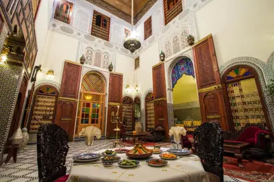 a room with a table with plates of food on it at Riad Ibn Khaldoun in Fès
